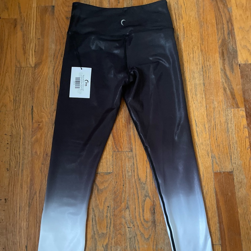 2 pair of Zyia leggings. Each size 4 and stretchy material